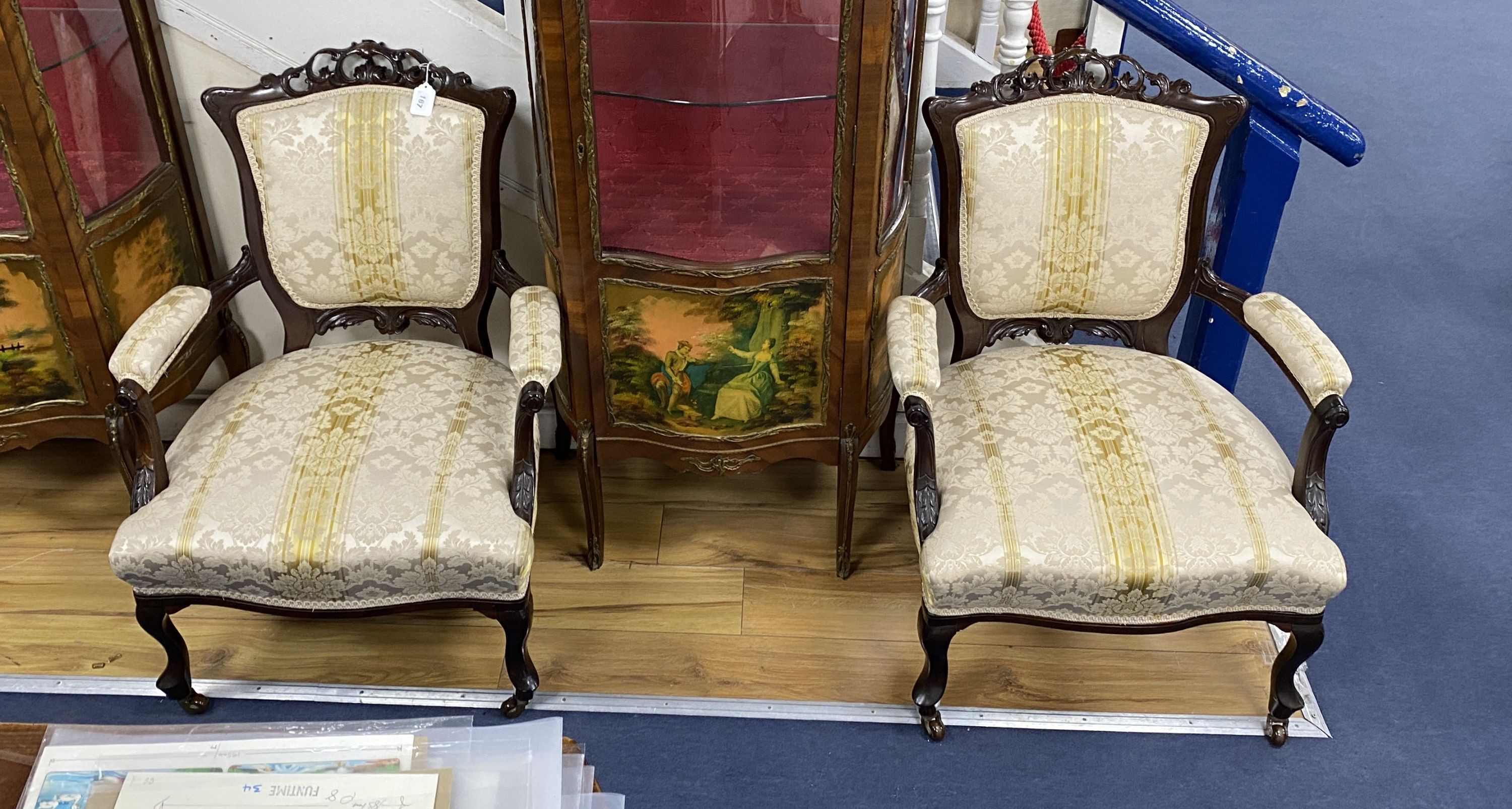 A pair of late Victorian carved mahogany open armchairs, width 66cm, depth 70cm, height 76cm
